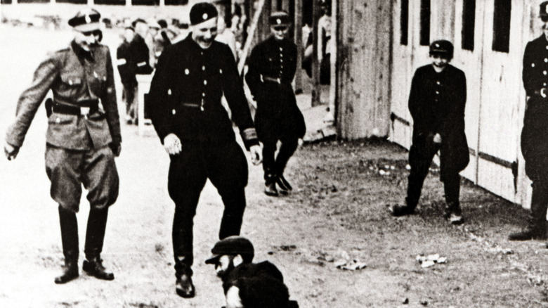 Guards torment an inmate at the Lodz ghetto