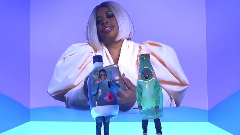 Kanye West and Lil Pump dressed as water bottles with Adele Givens on the screen on Saturday Night Live in 2018