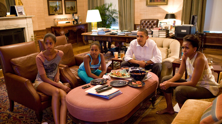 The Obama family watching TV in the residence