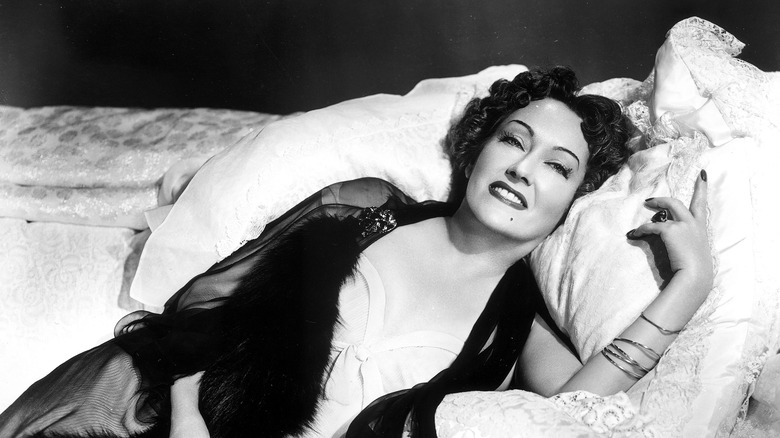 Gloria swanson smiling in bed