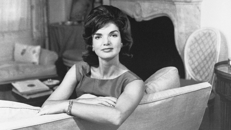 jackie Kennedy leans on sofa