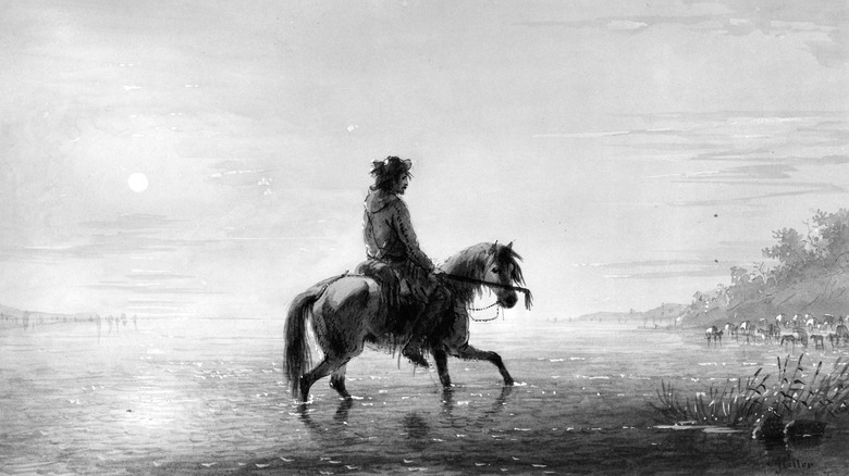 man on horseback crossing river