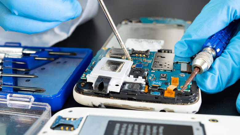 Cell phone technician fixing phone