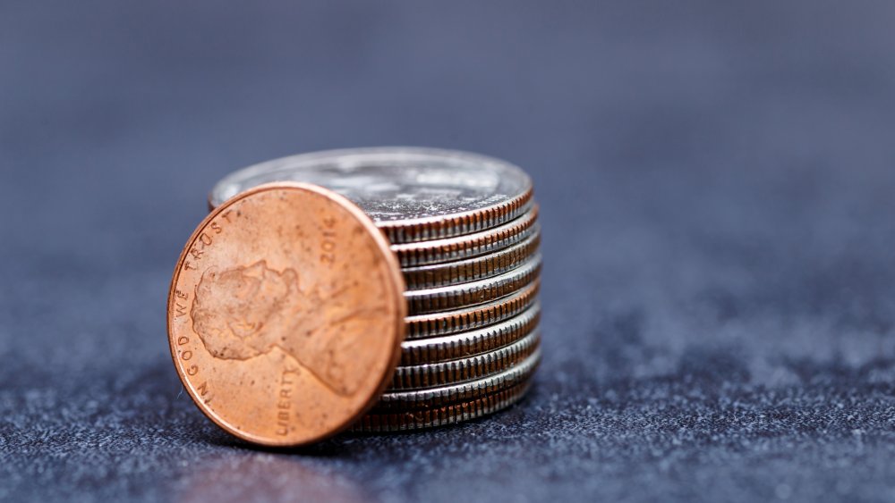 A stack of coins with a facing penny