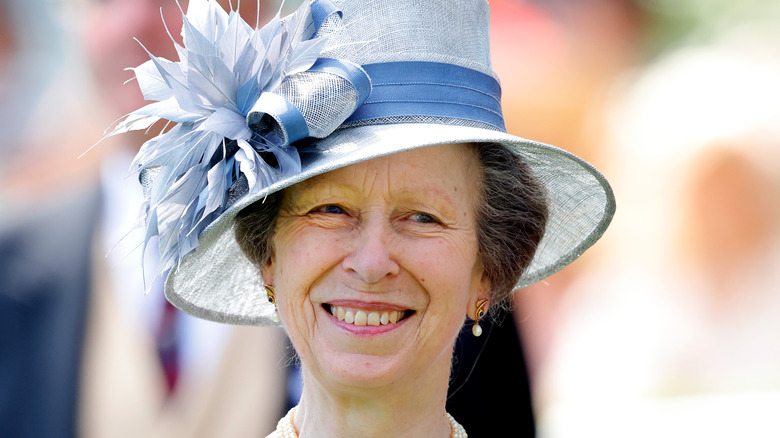 princess anne in a blue hat