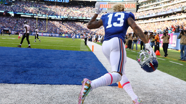 NFL player removing helmet after touchdown