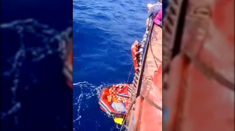 Man being rescued from a life raft