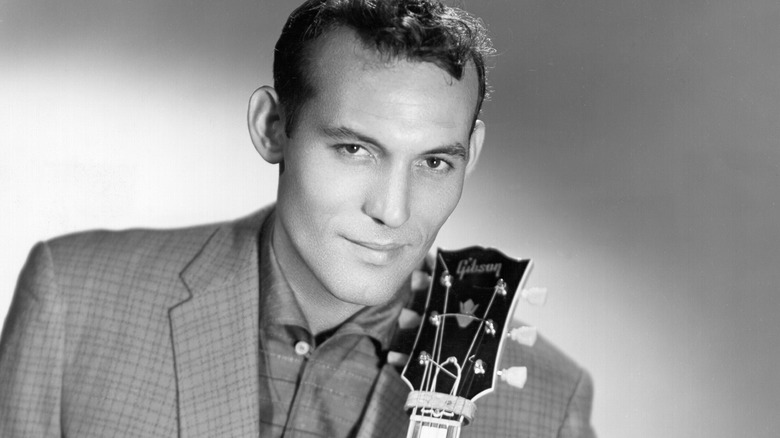 Carl Perkins posing with his guitar