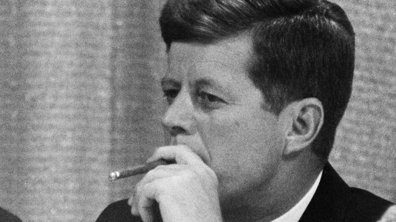 President Kennedy smokes a cigar