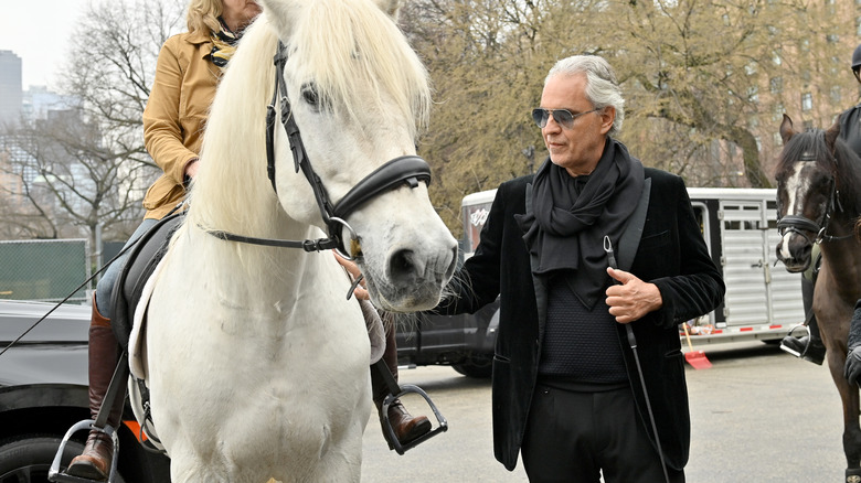 Andrea Bocelli patting a horse