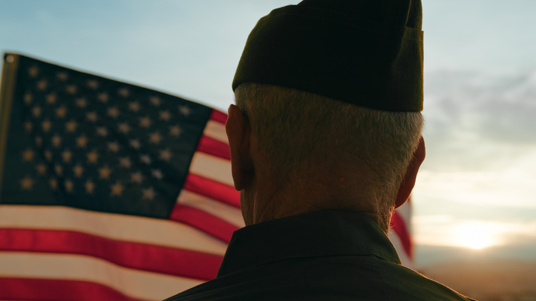 A soldier facing an American flag