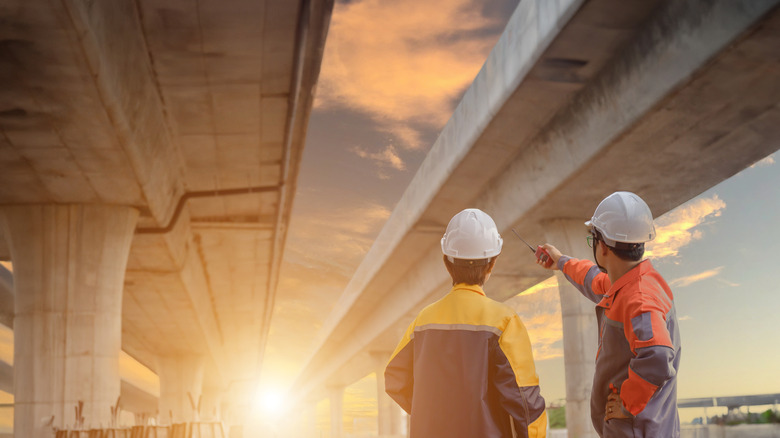 Two architects pointing at a bridge