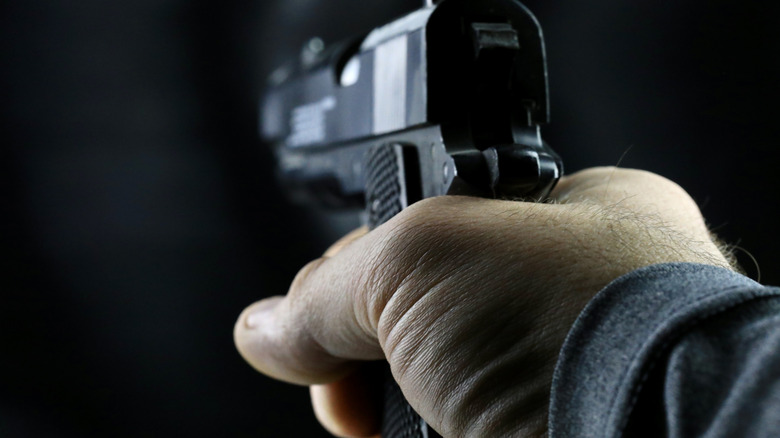 stock image of pistol in hand