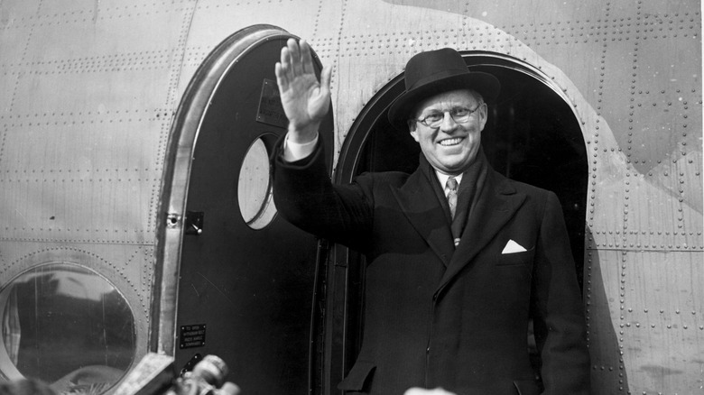 Joe Kennedy Sr smiling waving hat plane