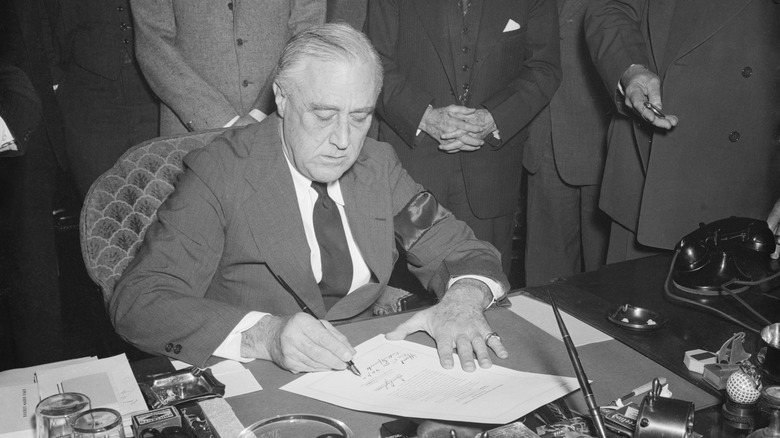 FDR signs declaration of war against Japan