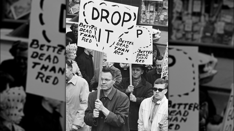 Counter-protesters holding signs encouraging nuking the Vietnamese