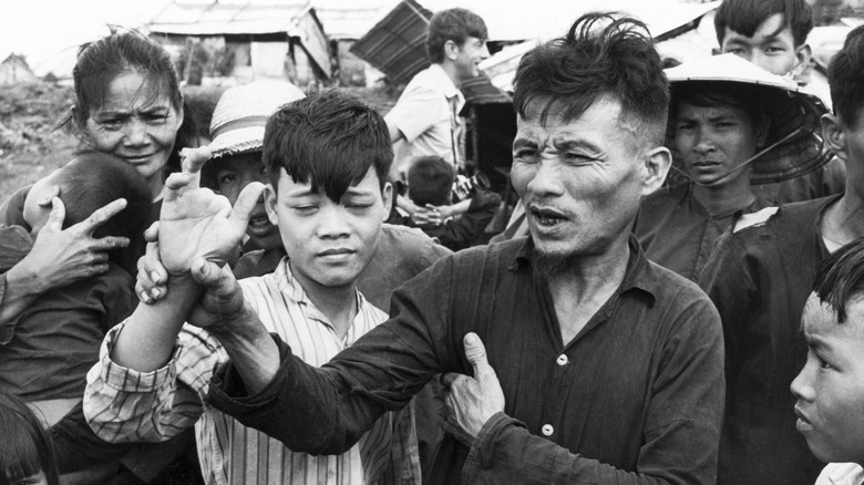 Survivors of the My Lai Massacre show their injuries