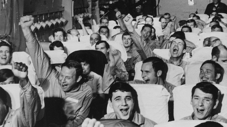 A flight full of cheering former POWs returning from Vietnam in 1973