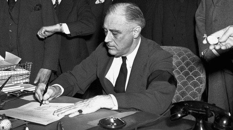 FDR signs declaration of war against Japan