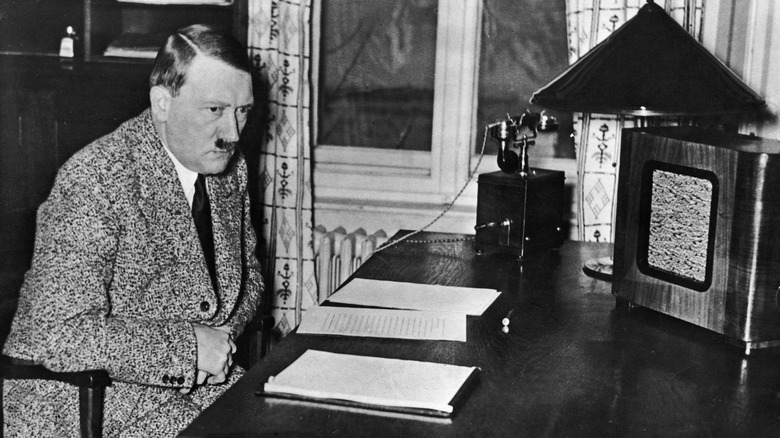 Hitler sits at desk