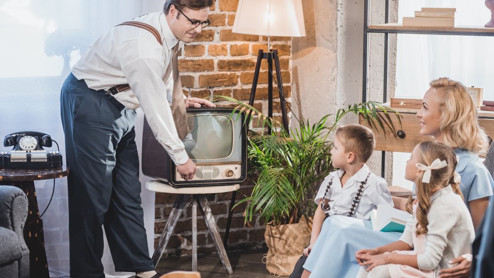 dad turning on TV for '50s family