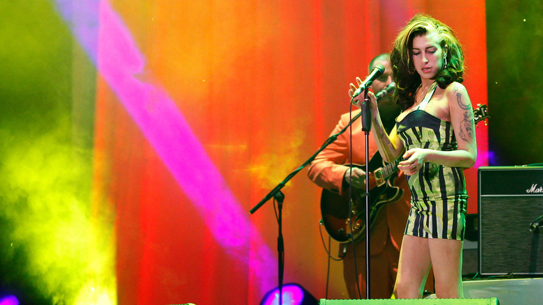 Amy Winehouse onstage in striped dress