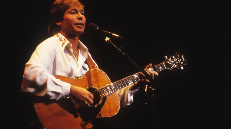 John Denver performing with guitar