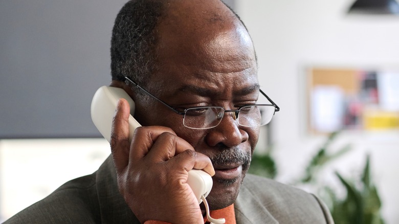 man listening to telephone receiver