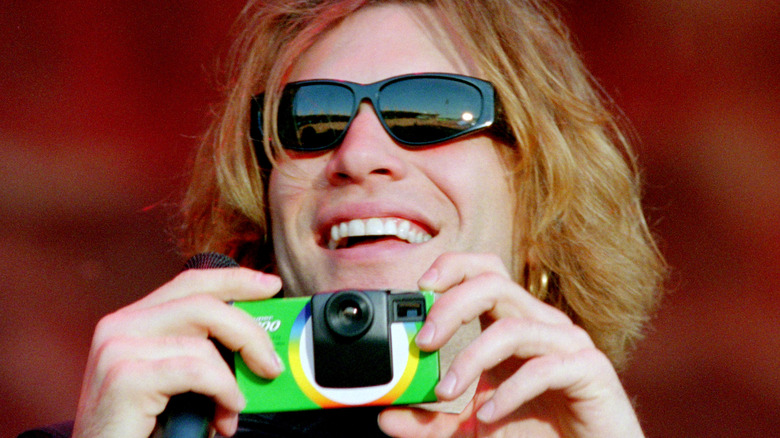 jon bon jovi sunglasses holding disposable camera