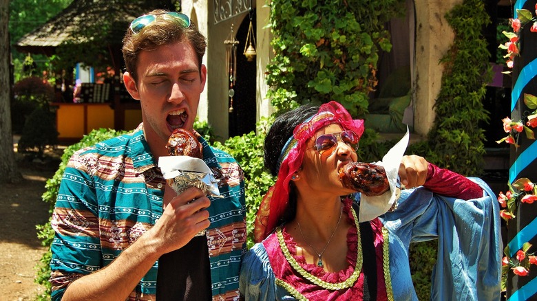 Couple eating turkey legs