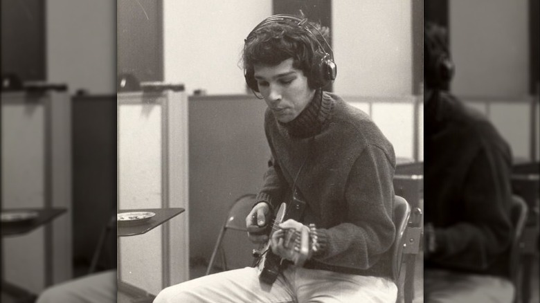 Chris Bell playing guitar in the studio