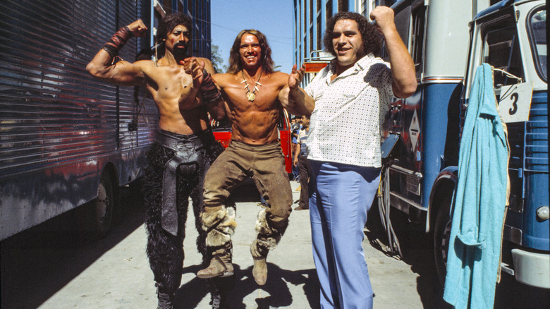 Arnold Schwarzenegger picked up by Wilt Chamberlain and Andre the Giant behind the scenes of Conan the Destroyer