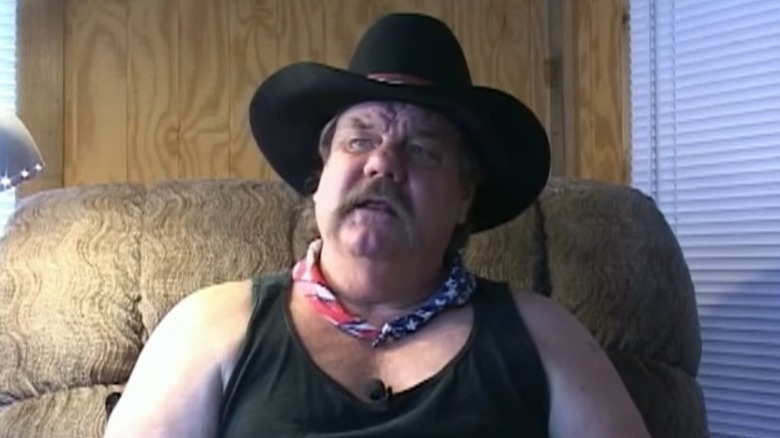 Blackjack Mulligan wearing a cowboy hat and speaking