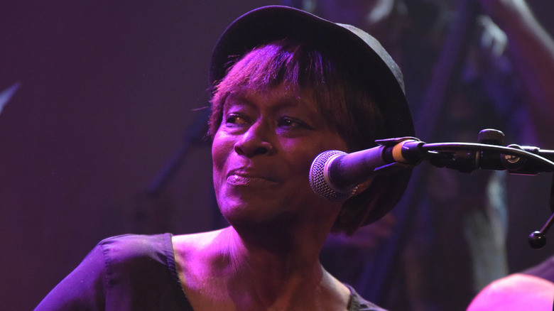 claudia lennear looking off onstage in front of a mic