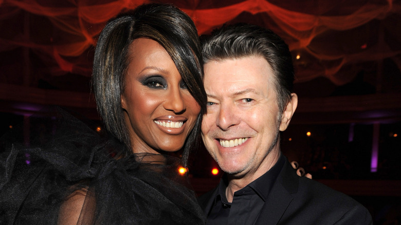 iman and david bowie smiling and embracing