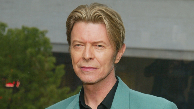 david bowie green blazer squinting into camera