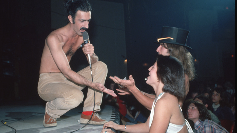 Frank Zappa singing to two fans