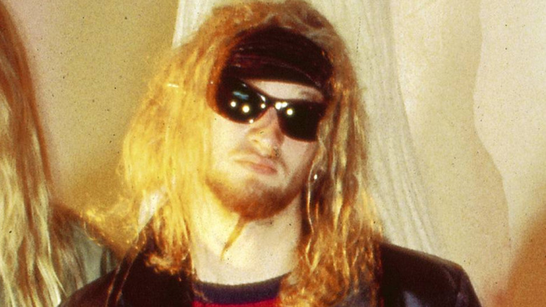 layne staley with sunglasses and long hair scowling in 1990