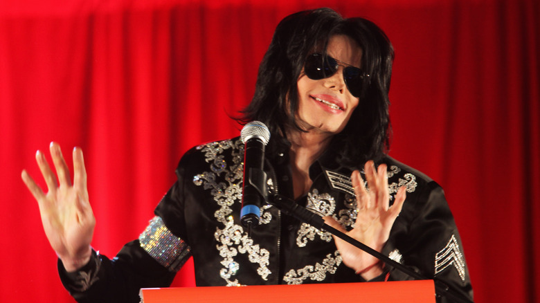 Michael Jackson in sunglasses and military outfit at podium