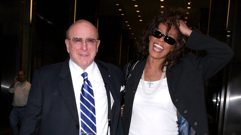 Clive Davis walking with Whitney Houston