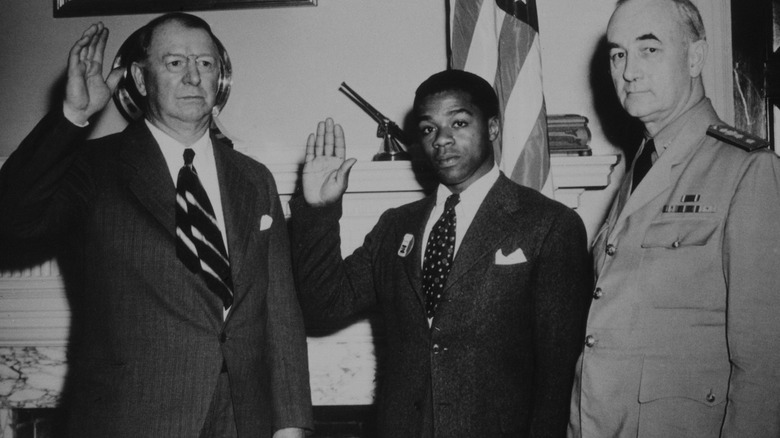 U.S. Army personnel raising hands