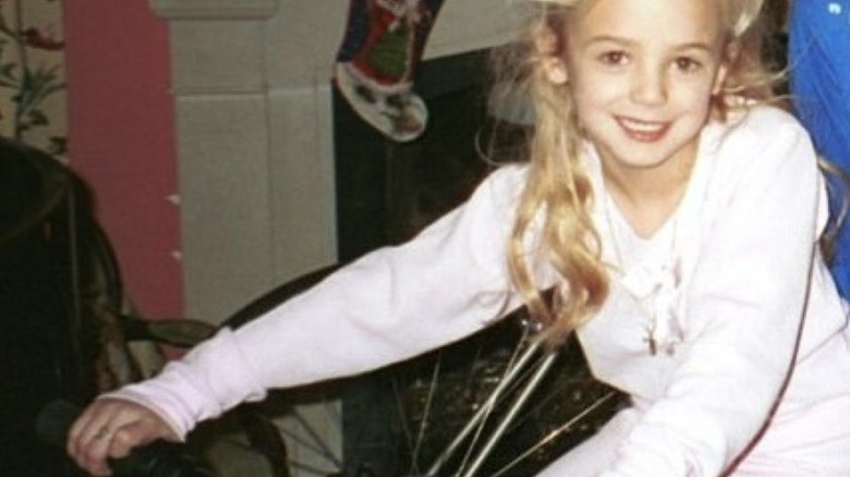 Jon Benet Ramsey smiling in pajamas at Christmas