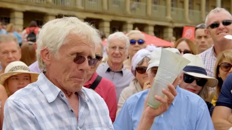 appraiser holds glass cup