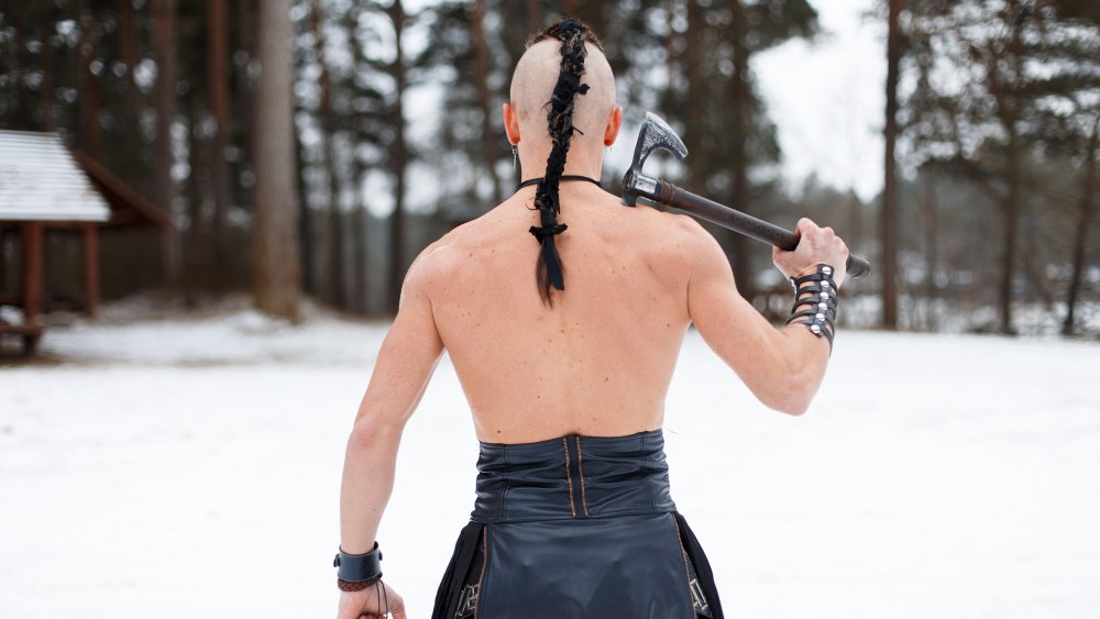 Viking standing with an axe in the snow