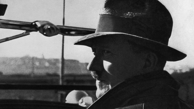 Adolf Hitler in car wearing hat