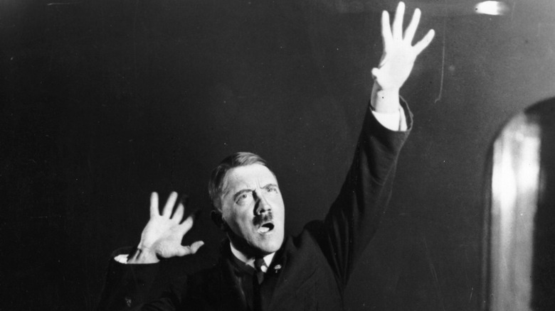 Adolf Hitler striking a pose hand raised