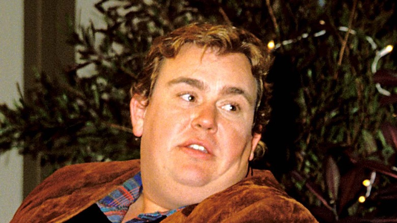 John Candy sat brown jacket