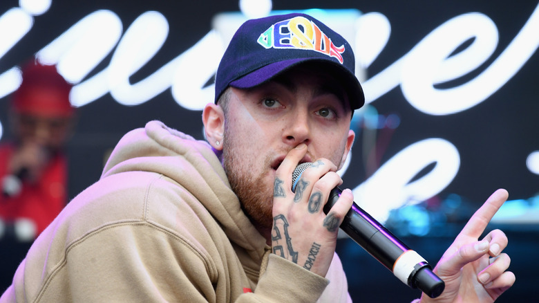 Mac Miller in cap with mic