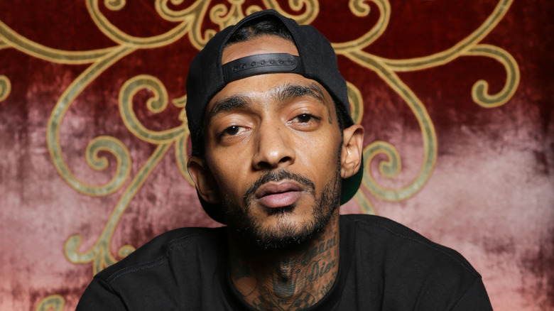 Nipsey Hussle in reverse baseball cap