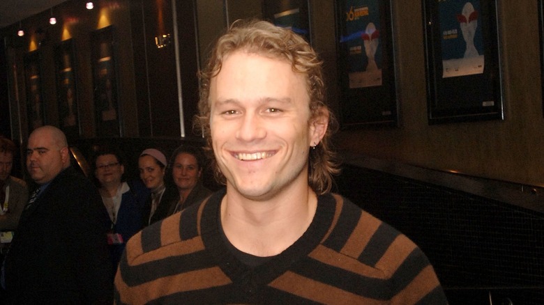 Heath Ledger striped shirt smiling at event